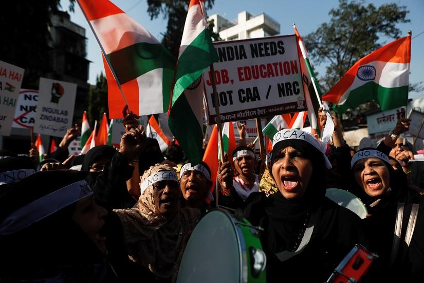 Demonstrators hold placards and India`s national flags during a protest against a new citizenship law in Mumbai, India, Jan 21, 2020. REUTERS