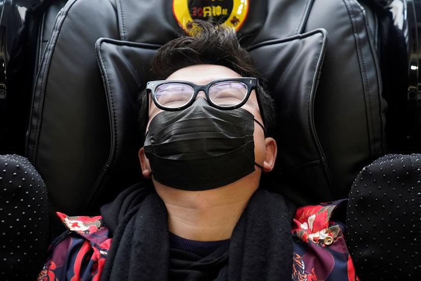 A passenger wears a mask at Shanghai railway station in Shanghai, China Jan 22, 2020. REUTERS