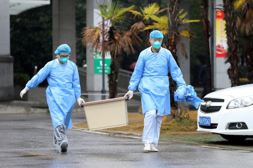 FILE PHOTO - Medical staff carry a box as they walk at the Jinyintan hospital, where the patients with pneumonia caused by the new strain of coronavirus are being treated, in Wuhan, Hubei province, China January 10, 2020. Picture taken January 10, 2020. REUTERS