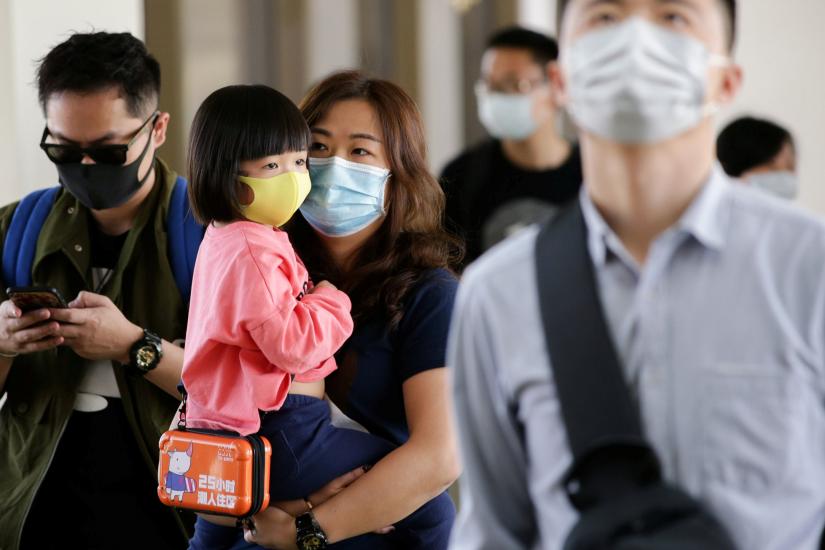 Passengers arriving from Guangzhou, China, wear masks at the Ninoy Aquino International Airport in Pasay, Philippines, January 23, 2020. REUTERS