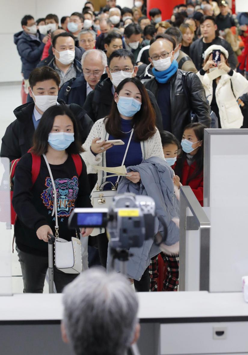 Passengers arriving from the Chinese city of Wuhan go through quarantine at Narita Airport in Chiba, Japan in this photo taken by Kyodo January 23, 2020. Kyodo/via REUTERS