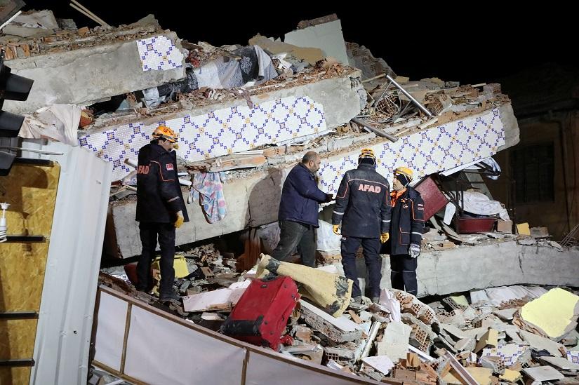 Rescue workers search on a collapsed building after an earthquake in Elazig, Turkey, Jan 25, 2020. REUTERS