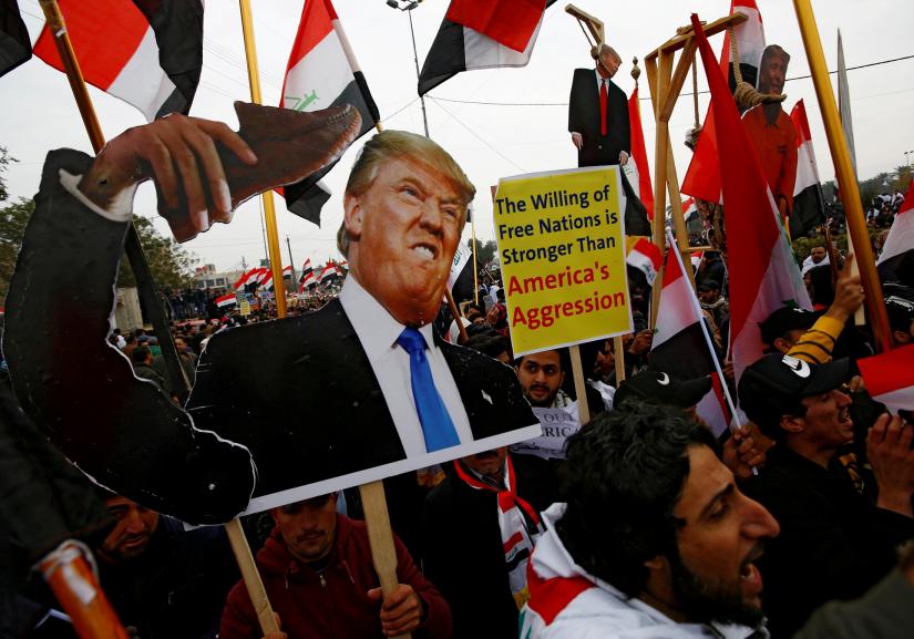 Supporters of Iraqi Shi`ite cleric Moqtada al-Sadr carry placards depicting U.S. President Donald Trump at a protest against what they say is U.S. presence and violations in Iraq, duri in Baghdad, Iraq January 24, 2020. REUTERS