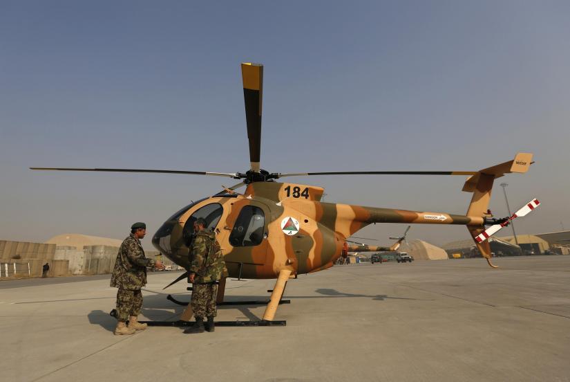 Members of the Afghan Air Force crew stand next to a helicopter at the military airport in Kabul December 18, 2014. REUTERS/File Photo