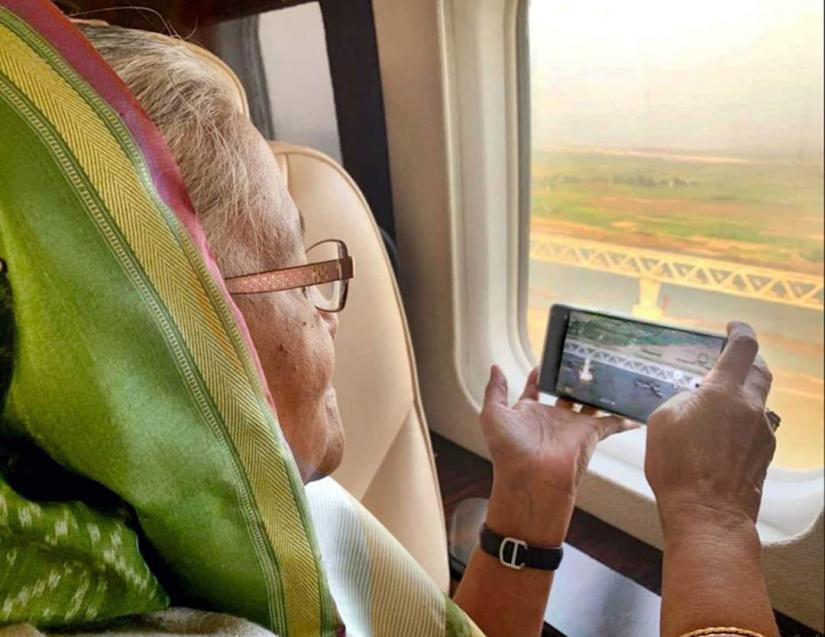Prime Minister Sheikh Hasina is seen taking picture of Pandma Bridge by a mobile on Jan 24. FOCUS BANGLA/File Photo