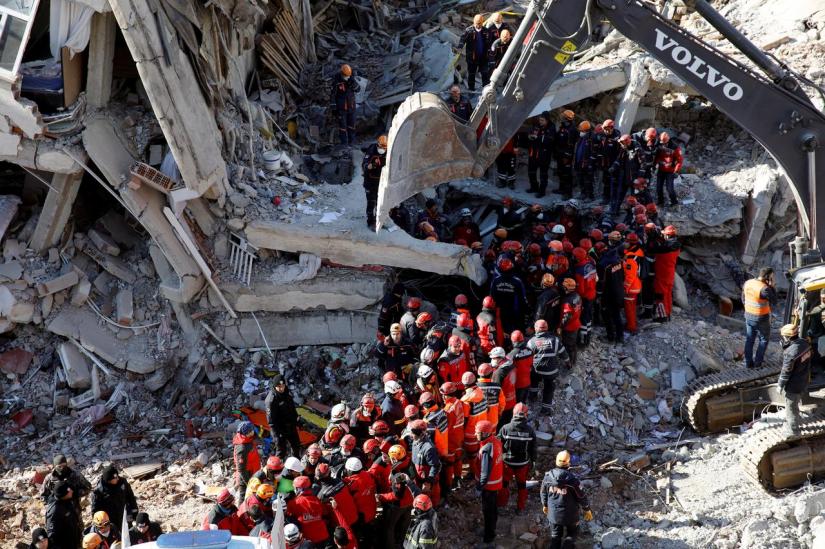 Rescue workers carry a body from the site of a collapsed building, after an earthquake in Elazig, Turkey, Jan 26, 2020. REUTERS
