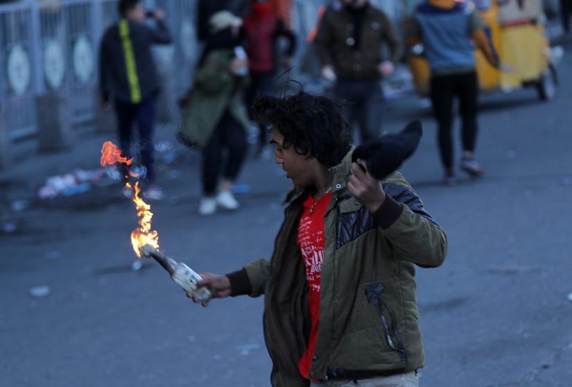An Iraqi demonstrator holds a Molotov cocktail during ongoing anti-government protests in Baghdad, Iraq January 26, 2020. REUTERS