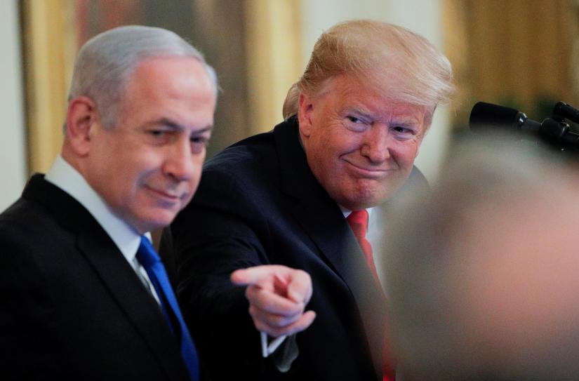 U.S. President Donald Trump points past Israel`s Prime Minister Benjamin Netanyahu as they discuss a Middle East peace plan proposal during a joint news conference in the East Room of the White House in Washington, U.S., January 28, 2020. REUTERS