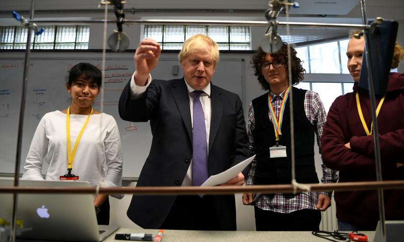 Britain`s Prime Minister Boris Johnson reacts as he listens to students during his visit to King`s Maths School, part of King`s College London University, in central London, Britain January 27, 2020. Pool via REUTERS