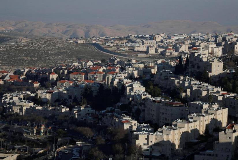 A general view picture shows Pisgat Zeev in the foreground and the Shuafat refugee camp behind the Israeli barrier in East Jerusalem, in an area Israel annexed to Jerusalem after capturing it in the 1967 Middle East war Jan 26, 2020. REUTERS