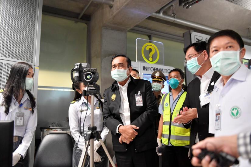 Thailand`s Prime Minister Prayuth Chan-ocha wearing a protective mask looks through a thermographic imaging device during a visit at the arrival hall at the Bangkok`s Suvarnabhumi International airport, January 26, 2020. Picture taken January 26, 2020. Thailand Government House/Handout via REUTERS
