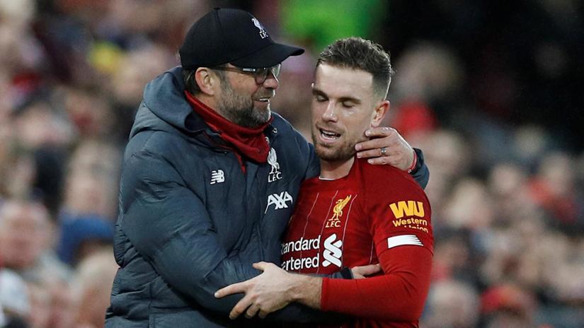 Soccer Football - Premier League - Liverpool v Southampton - Anfield, Liverpool, Britain - Feb 1, 2020 Liverpool`s Jordan Henderson is embraced by manager Juergen Klopp after being substituted off REUTERS