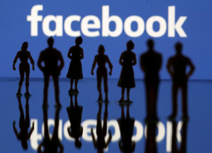 FILE PHOTO: Small toy figures are seen in front of Facebook logo in this illustration picture, April 8, 2019. REUTERS