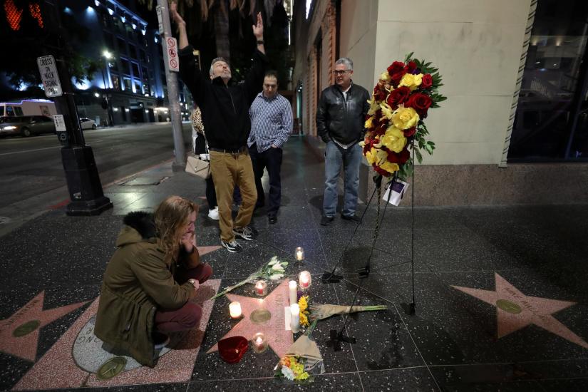 A man reacts to the news of the death of actor Kirk Douglas as fan Ed Robinson mourns his passing at the site of Douglas' star at Hollywood Boulevard and Vine in Los Angeles, California, U.S. February 5, 2020. REUTERS