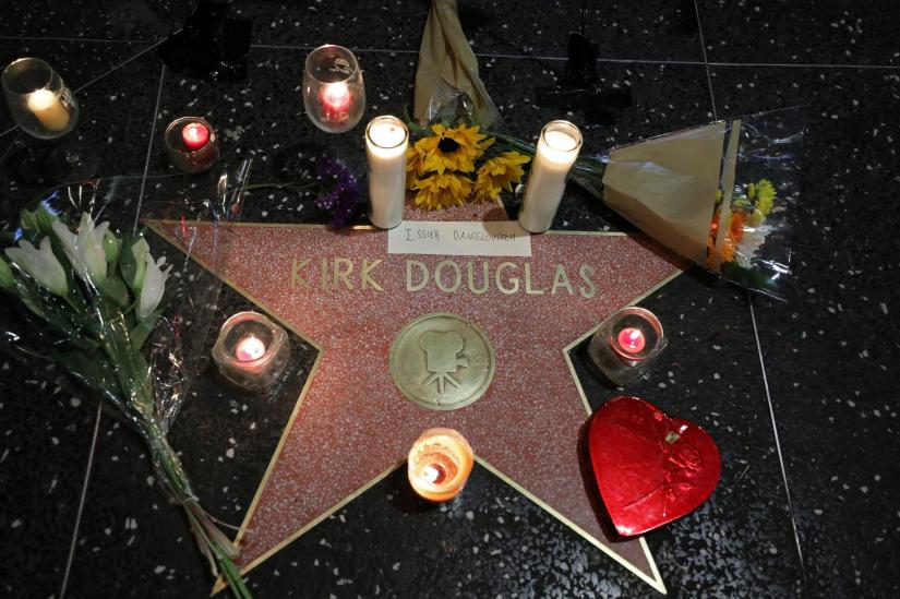 Flowers and candles surround the star of actor Kirk Douglas at Hollywood Boulevard and Vine in Los Angeles, California, U.S. February 5, 2020. REUTERS