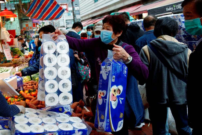 A customer picks toilet paper at a market, following the outbreak of a new coronavirus, in Hong Kong, China February 8, 2020. REUTERS