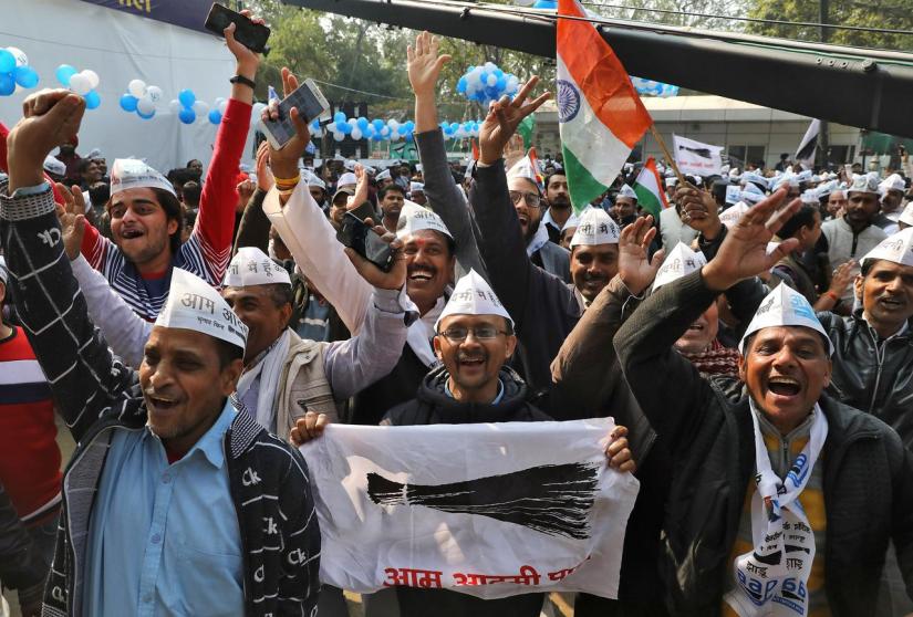 Supporters of Aam Aadmi Party (AAP) celebrate after learning of the initial poll results outside its party headquarters in New Delhi, India, Feb 11, 2020. REUTERS