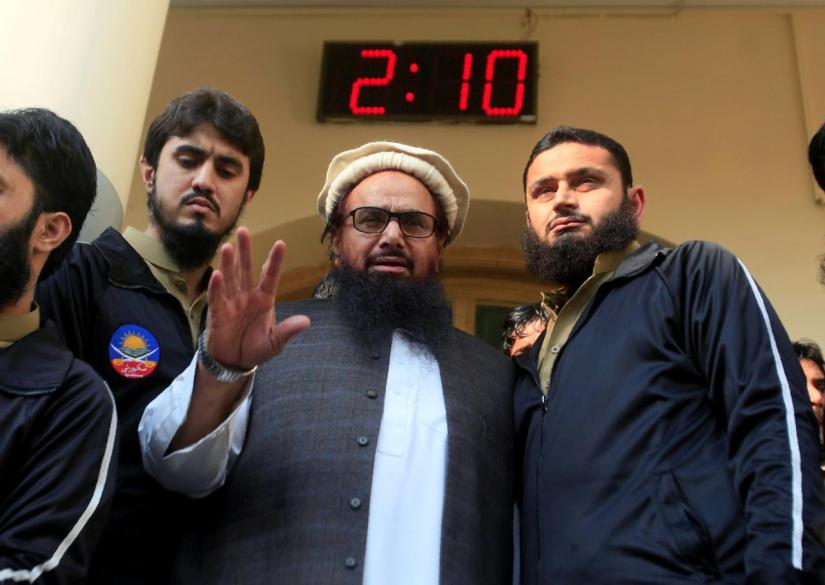 FILE PHOTO: Hafiz Saeed speaks with supporters after attending Friday Prayers in Lahore, Pakistan Nov 24, 2017. REUTERS