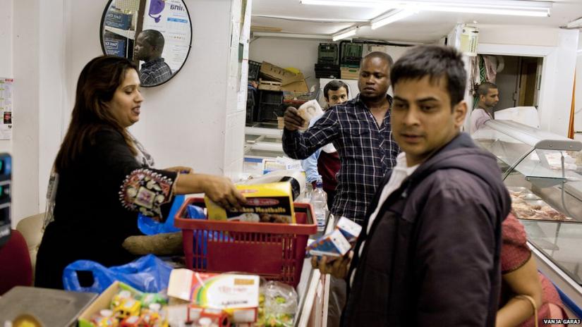 A Bangladeshi woman serving in a shop in Cardiff. PHOTO via BBC