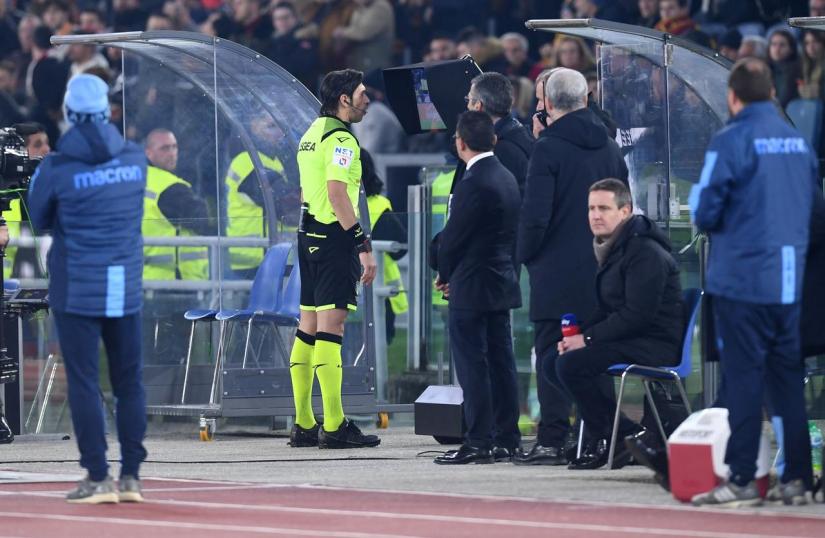 FILE PHOTO: Soccer Football - Serie A - AS Roma v Lazio - Stadio Olimpico, Rome, Italy - Jan 26, 2020 The referee consults a VAR monitor during the match REUTERS