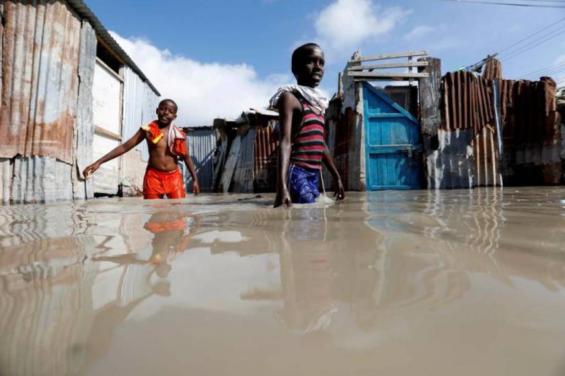 Somali children wade through flood waters after heavy rain in Mogadishu, Somalia Oct 21, 2019. REUTERS