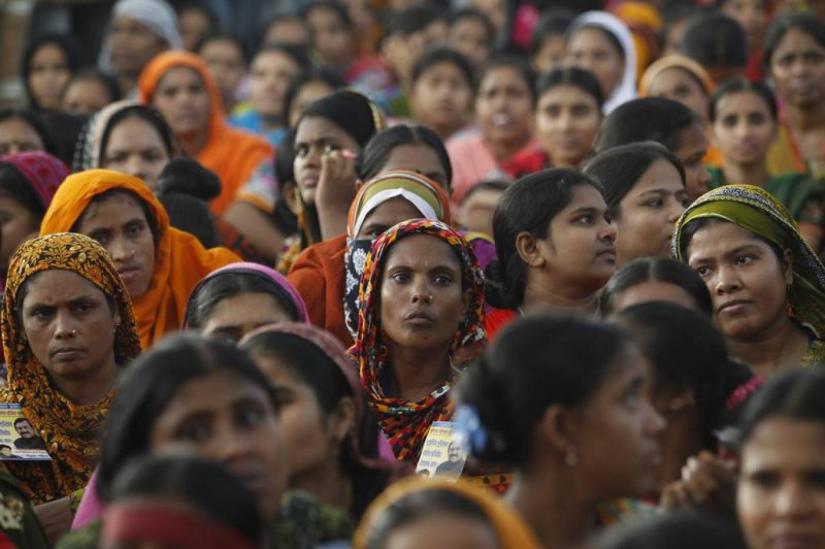 Garment workers listen to speakers during a rally demanding an increase to their minimum wage in Dhaka Sept 21, 2013. REUTERS/File Photo