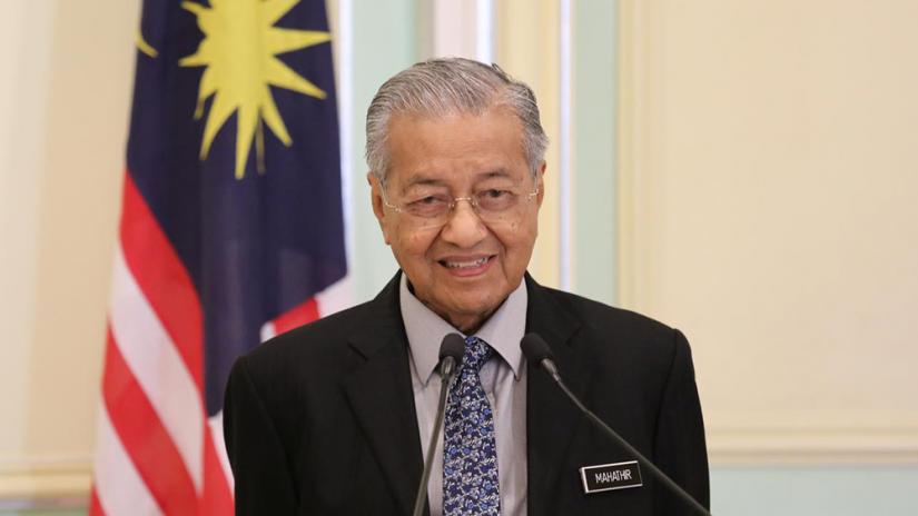 FILE PHOTO: Malaysia`s Prime Minister Mahathir Mohamad speaks during a joint news conference with Pakistan`s Prime Minister Imran Khan (not pictured) in Putrajaya, Malaysia, Feb 4, 2020. REUTERS