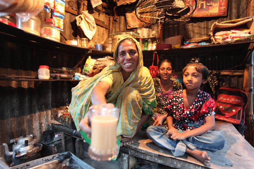 A woman, accompanied by her daughters, is seen selling tea at her tea stall in a village in Bangladesh. PHOTO/UNDP Bangladesh