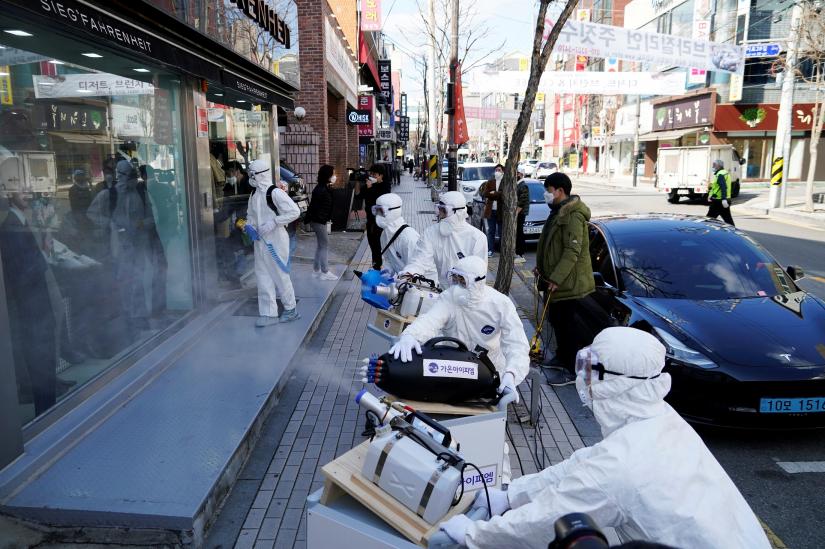 Employees from a disinfection service company sanitize a shopping district in Seoul, South Korea, February 27, 2020. REUTERS