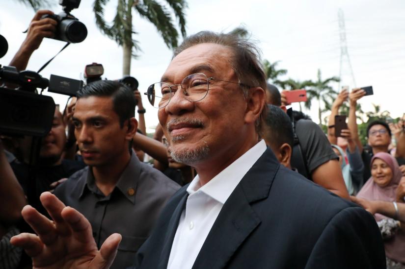 Malaysian politician Anwar Ibrahim waves to his supporters after a news conference in Petaling Jaya, Malaysia, February 26, 2020. REUTERS