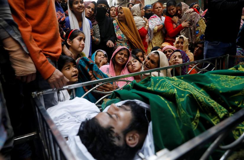 Relatives mourn next to the body of Muddasir Khan, who was wounded on Tuesday in a clash between people demonstrating for and against a new citizenship law, after he succumbed to his injuries, in a riot affected area in New Delhi, India, February 27, 2020. REUTERS