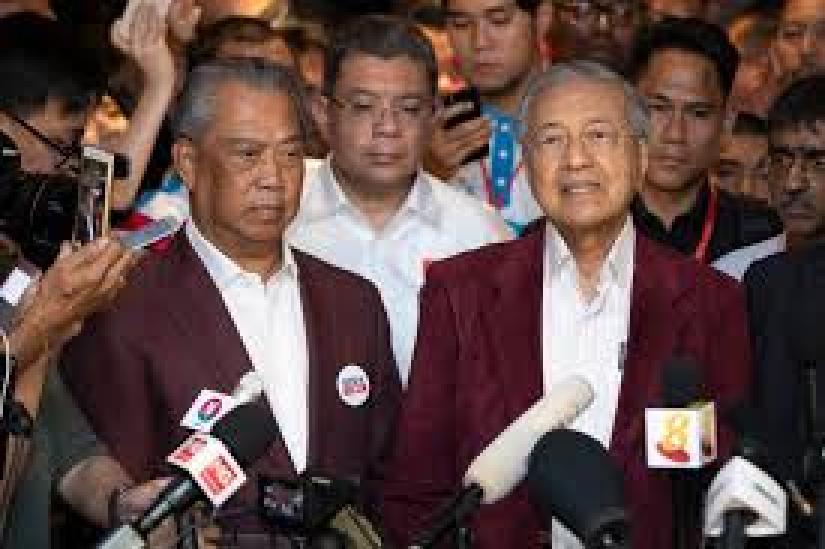 Mahathir Mohamad (right) speaks to media to announce victory on election day as Muhyiddin Yassin, president of Mahathir’s Bersatu party, stands next to him during a press conference at a hotel in Kuala Lumpur, May 9, 2018.