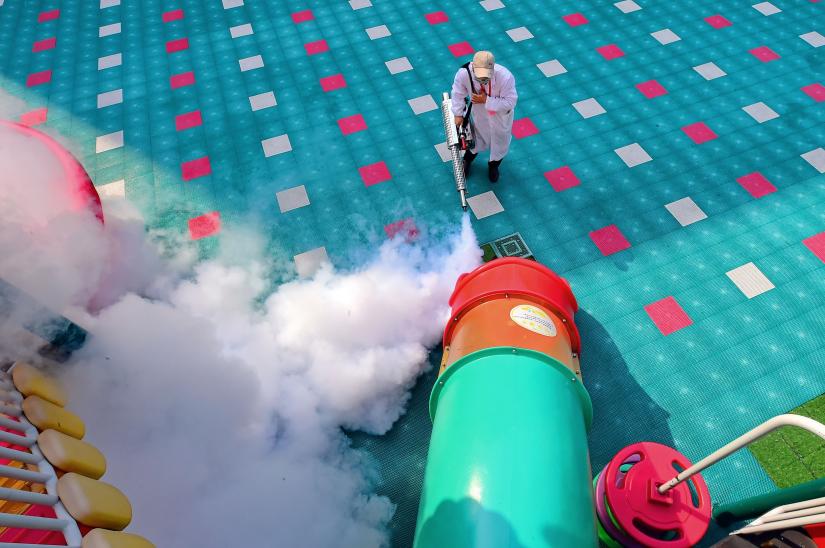 A worker disinfects playground equipment inside a kindergarten as students` returning has been delayed due to the novel coronavirus outbreak, in Ganzhou, Jiangxi province, China March 2, 2020. Picture taken March 2, 2020. China Daily via REUTERS