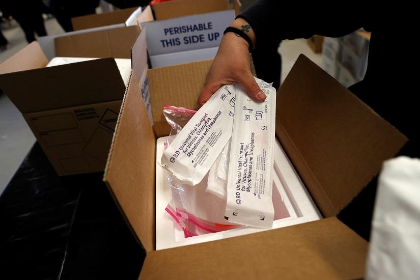 FILE PHOTO: Emergency Medical Technician Emma Vargas prepares boxes of coronavirus (COVID-19) testing kits for use by medical field personnel at a New York State emergency operations incident command center during the Coronavirus outbreak in New Rochelle, New York, US, Mar 17, 2020. REUTERS