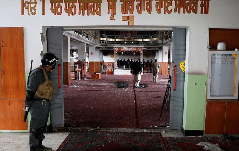 An Afghan policeman inspects inside a Sikh religious complex after an attack in Kabul, Afghanistan March 25, 2020 Reuters