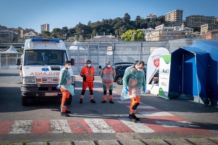 Medical workers are seen near the ambulances as they drive onto the docked `Splendid` passenger ship as the first patients with coronavirus disease (COVID-19) are transported to the ship, which has been transformed into a hospital, as Italy struggles to cope with the number of people infected with the virus, at the port of Genoa, Italy, Mar 23, 2020. Ufficio Stampa Regione Liguria/Marco Gozzi/Handout via REUTERS