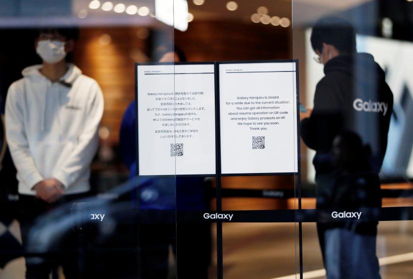`Closed` notices are displayed at the entrance of Galaxy Harajuku, a flagship store of the Galaxy brand mobile computing devices by Samsung Electronics, during the coronavirus disease (COVID-19) outbreak, in Tokyo, Japan March 26, 2020. Picture taken March 26, 2020. REUTERS