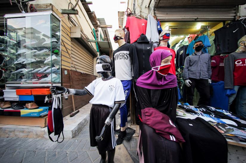 A vendor sells protective face masks and clothes, following the outbreak of coronavirus disease (COVID-19), in Manama, Bahrain, March 26, 2020. REUTERS