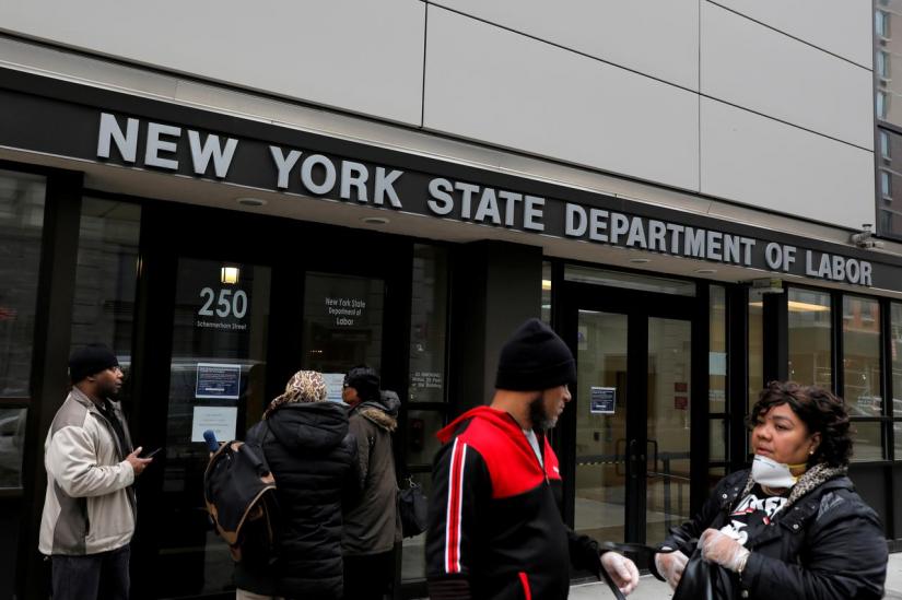 FILE PHOTO: People gather at the entrance for the New York State Department of Labor offices, which closed to the public due to the coronavirus disease (COVID-19) outbreak in the Brooklyn borough of New York City, US, Mar 20, 2020. REUTERS